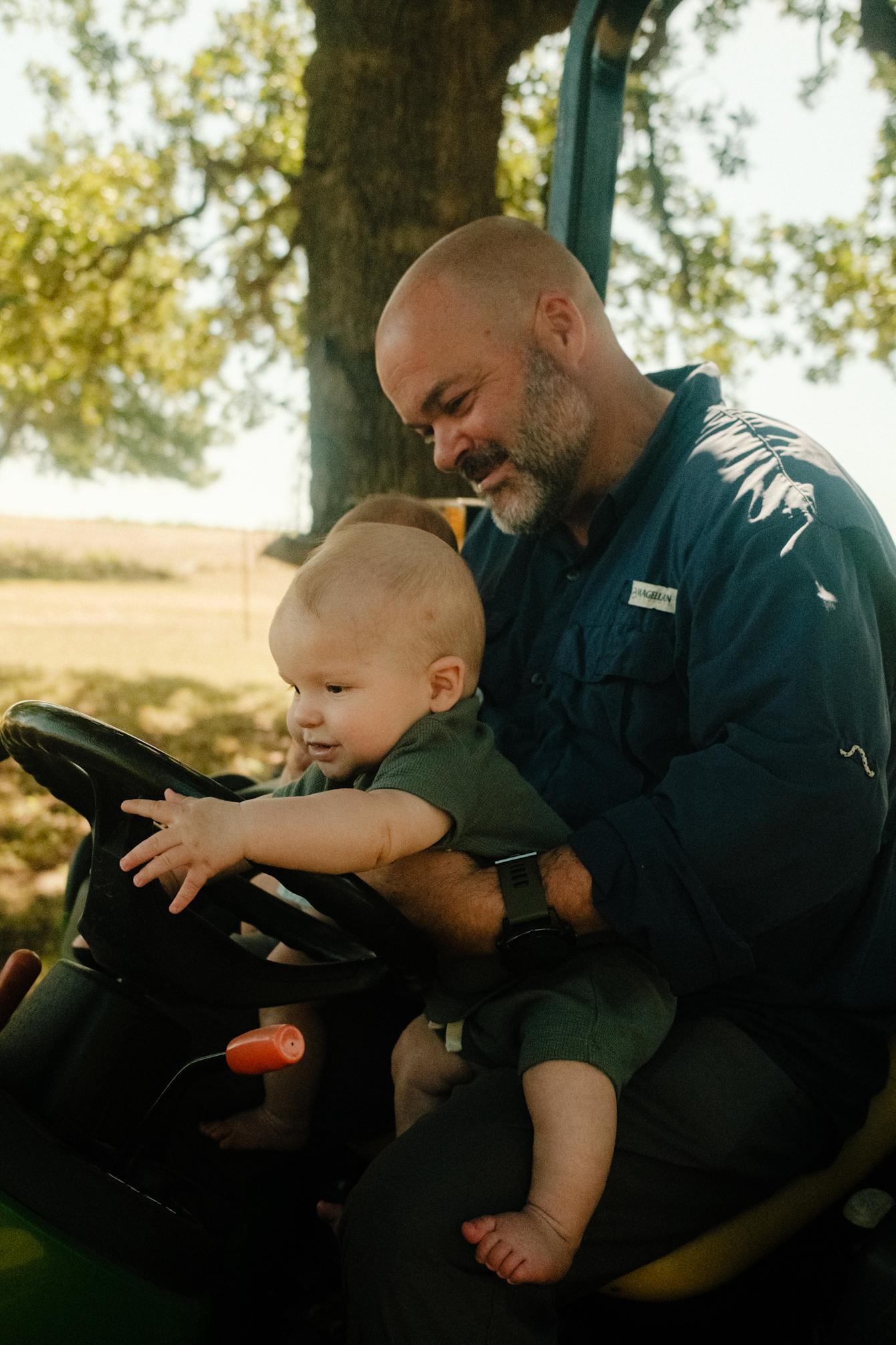 Sawyer steering the tractor #1