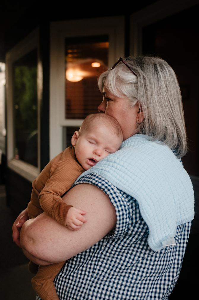 Grandma holding sleepy Sawyer