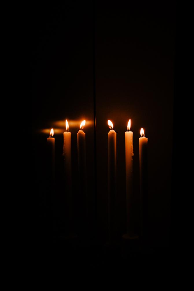 The lit candles reflection in the TV.