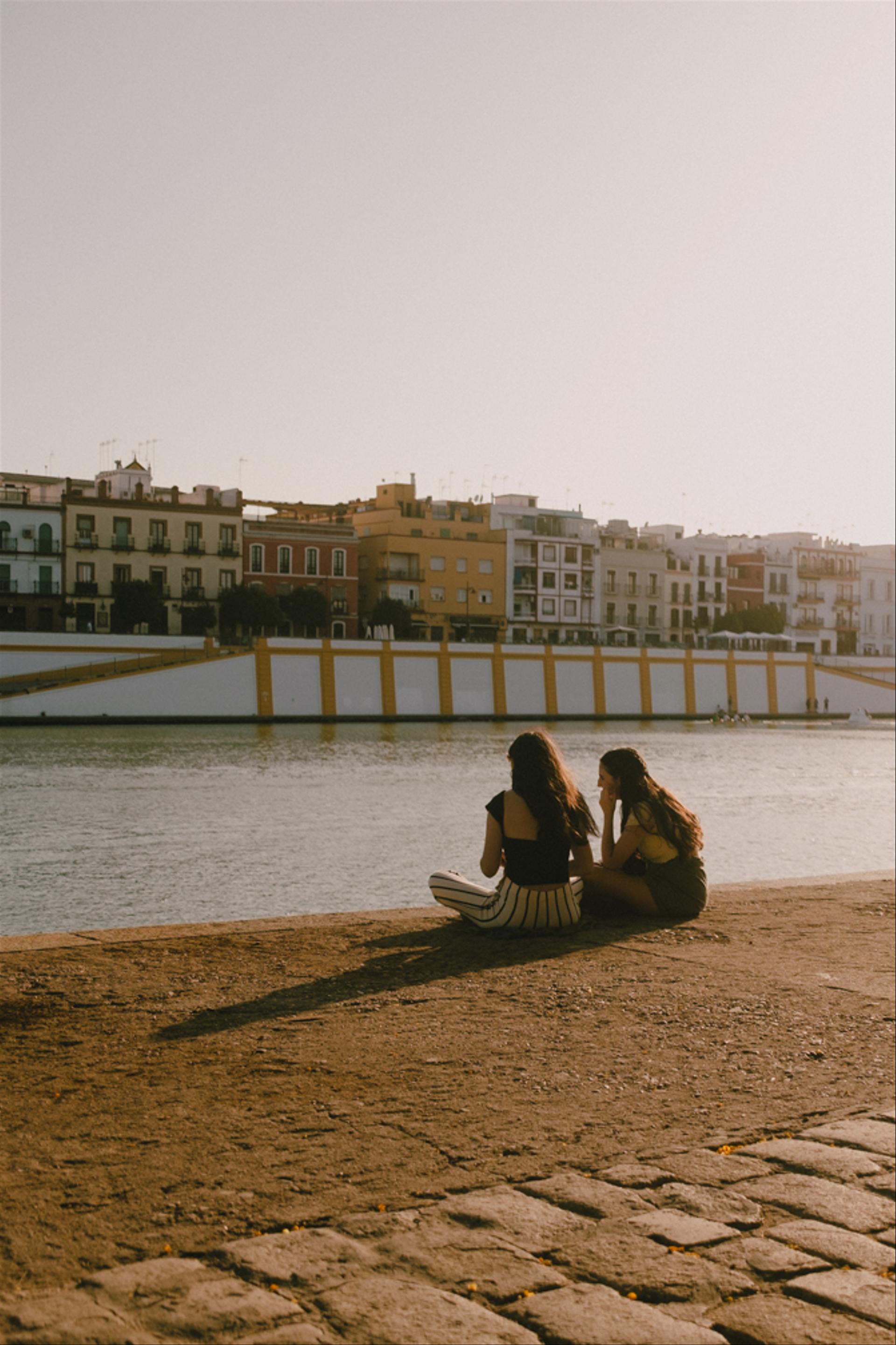 Women sitting by the river.